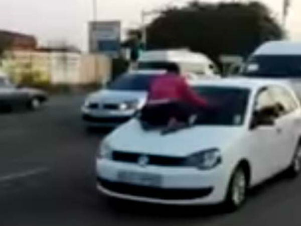 WATCH: Scorned wife clings to car bonnet as man drives away with 'mistress' WATCH: Scorned wife clings to car bonnet as man drives away with 'mistress'