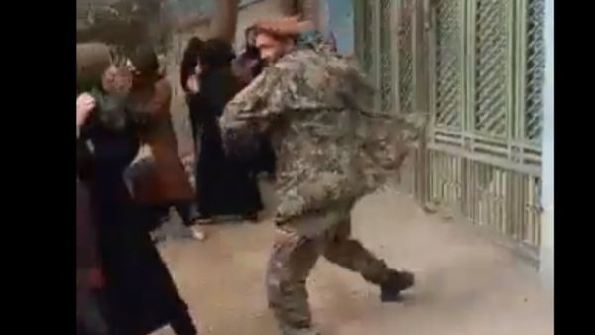 Taliban offical beating girls Taliban offical beating girls