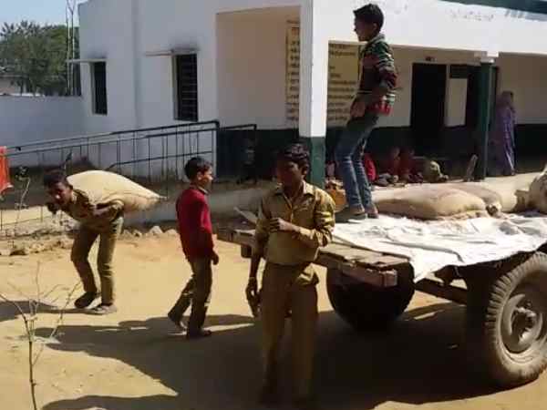 मिड-डे मील के राशन की बोरियां ढोते हैं बच्चे