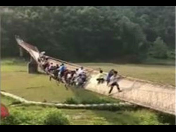 WATCH: Scary video showing people hanging by the railing on a bridge in China is going viral WATCH: Scary video showing people hanging by the railing on a bridge in China is going viral