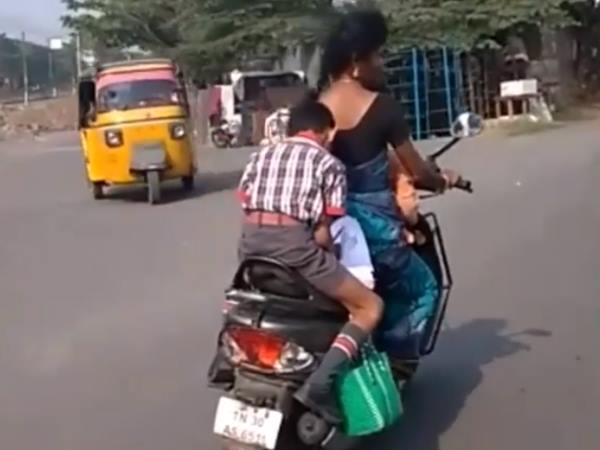 kiren rijiju share viral video boy doing homework on scooter mother driving kiren rijiju share viral video boy doing homework on scooter mother driving