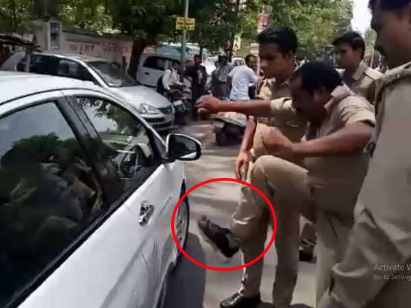 A policeman in Kanpur hitting a car after it accident A policeman in Kanpur hitting a car after it accident