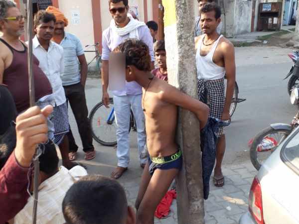A boy tied with pole and beaten by public in Varanasi A boy tied with pole and beaten by public in Varanasi