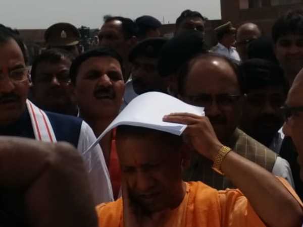 CM Yogi Adityanath suffers in heat of sun in Allahabad CM Yogi Adityanath suffers in heat of sun in Allahabad