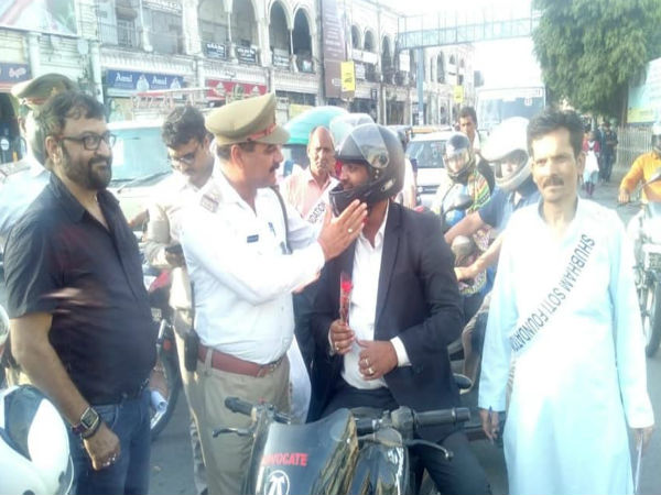 Lucknow traffic police gives red rose to a man for wearing helmet, leads to fight with wife. Lucknow traffic police gives red rose to a man for wearing helmet, leads to fight with wife.