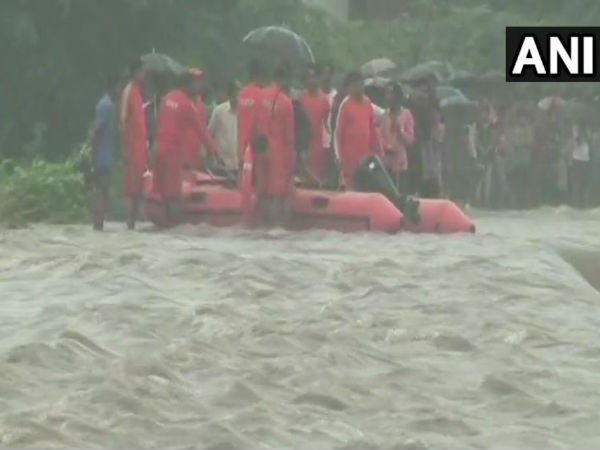 An NDRF team rescued around 12 people who were stranded in the middle of a river in Godhra, Gujarat An NDRF team rescued around 12 people who were stranded in the middle of a river in Godhra, Gujarat