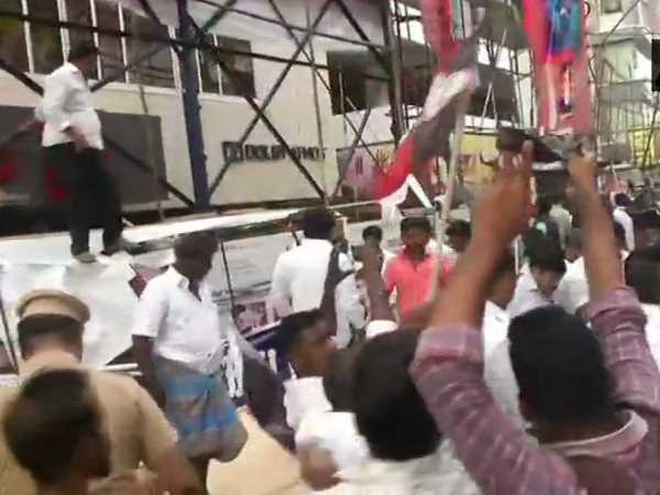 AIADMK workers vandalise posters of Sarkar movie outside Kasi theatre in Chennai AIADMK workers vandalise posters of Sarkar movie outside Kasi theatre in Chennai
