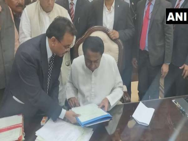 Bhopal: Madhya Pradesh Chief Minister Kamal Nath signs on the files for farm loan waiver Bhopal: Madhya Pradesh Chief Minister Kamal Nath signs on the files for farm loan waiver