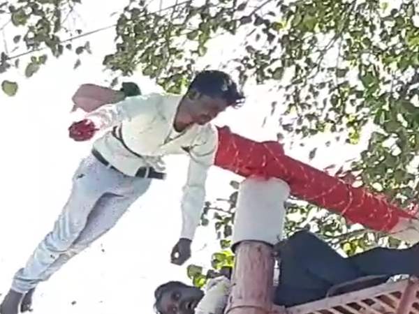 Devotees hanging on 25 feet long pillar of temple at ratlam Devotees hanging on 25 feet long pillar of temple at ratlam