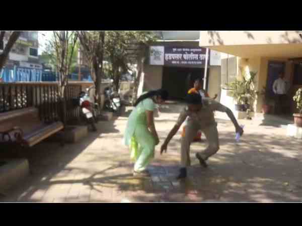 woman sprinkled kerosene in front of police station woman sprinkled kerosene in front of police station