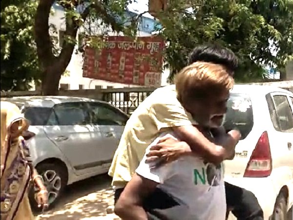 father carry his son on his back for treatment in hospital father carry his son on his back for treatment in hospital