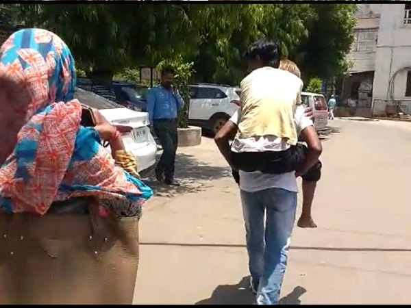 father carry his son on his back for treatment in hospital father carry his son on his back for treatment in hospital