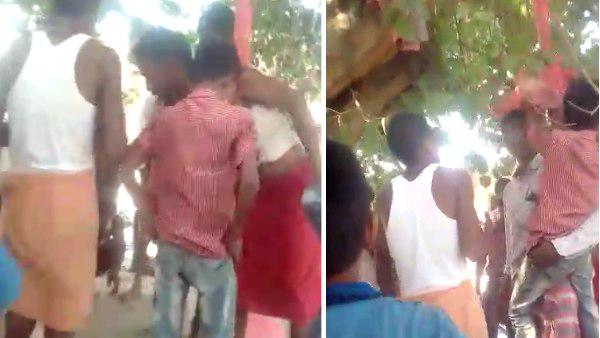 villagers tied two boys on the tree and beat him villagers tied two boys on the tree and beat him