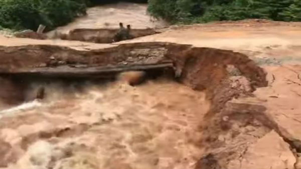 Terrifying moment motorcyclist and passenger plunge into flash flood after bridge collapses in Cambodia. Terrifying moment motorcyclist and passenger plunge into flash flood after bridge collapses in Cambodia.