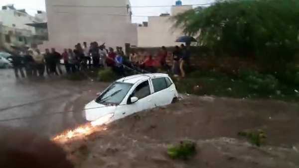people pulling ropes tied in the car to save from drowing people pulling ropes tied in the car to save from drowing