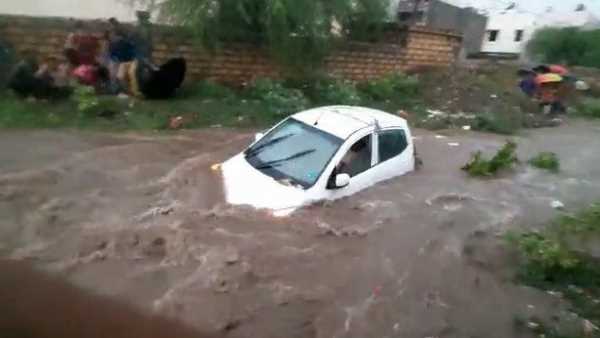 people pulling ropes tied in the car to save from drowing people pulling ropes tied in the car to save from drowing