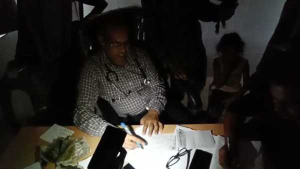 doctors treating patient with mobile torch light in hospital doctors treating patient with mobile torch light in hospital