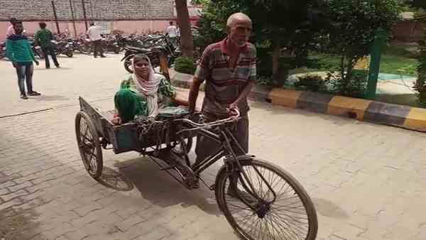 old man peddles cycle rickshaw carrying her wife for treatment old man peddles cycle rickshaw carrying her wife for treatment