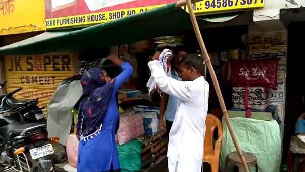 woman beats a man with her slippers woman beats a man with her slippers