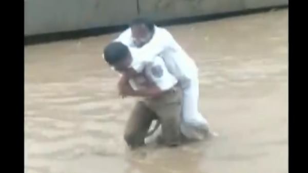 cop carried a sick man on his shoulders by making his way through a waterlogged route in Hyderabad cop carried a sick man on his shoulders by making his way through a waterlogged route in Hyderabad