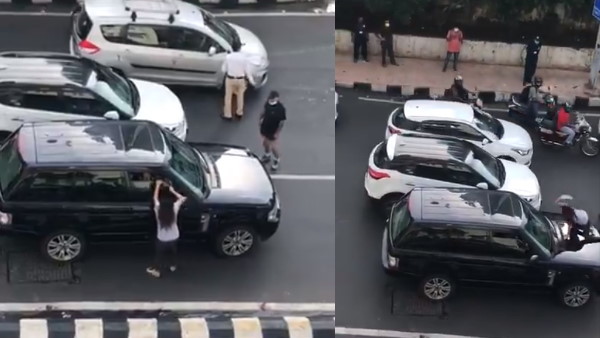 महिला एसयूवी के बोनट पर जाकर बैठ गई
