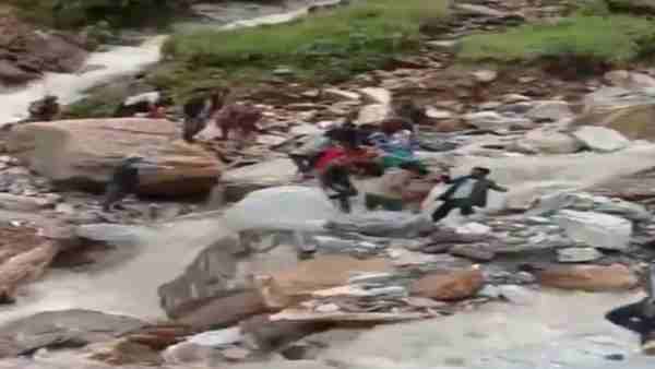 Villagers transported a patient to a hospital on a temporary stretcher made of wood logs in Munsiyari area of Pithoragarh Villagers transported a patient to a hospital on a temporary stretcher made of wood logs in Munsiyari area of Pithoragarh