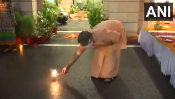 Yogi Adityanath lights a firecracker at his official residence in Lucknow as part of deepotsav Yogi Adityanath lights a firecracker at his official residence in Lucknow as part of deepotsav