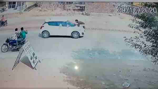 crooks carrying constable on the bonnet of a car in film style crooks carrying constable on the bonnet of a car in film style