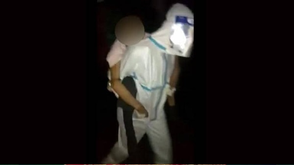 Health worker carries corona patient on back and travels half km to reach ambulance in Assam Health worker carries corona patient on back and travels half km to reach ambulance in Assam