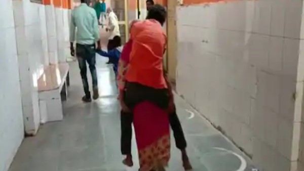 woman carrying her ill husband on shoulders in pratapgarh video viral woman carrying her ill husband on shoulders in pratapgarh video viral