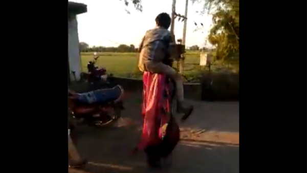 madhya pradesh tribal woman in Guna beaten up forced to carry her relatives on her shoulders as punishment madhya pradesh tribal woman in Guna beaten up forced to carry her relatives on her shoulders as punishment