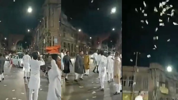 Watch Video: Cash Rain in Hyderabad: Man throws Rs 500 notes in air at Charminar Watch Video: Cash Rain in Hyderabad: Man throws Rs 500 notes in air at Charminar