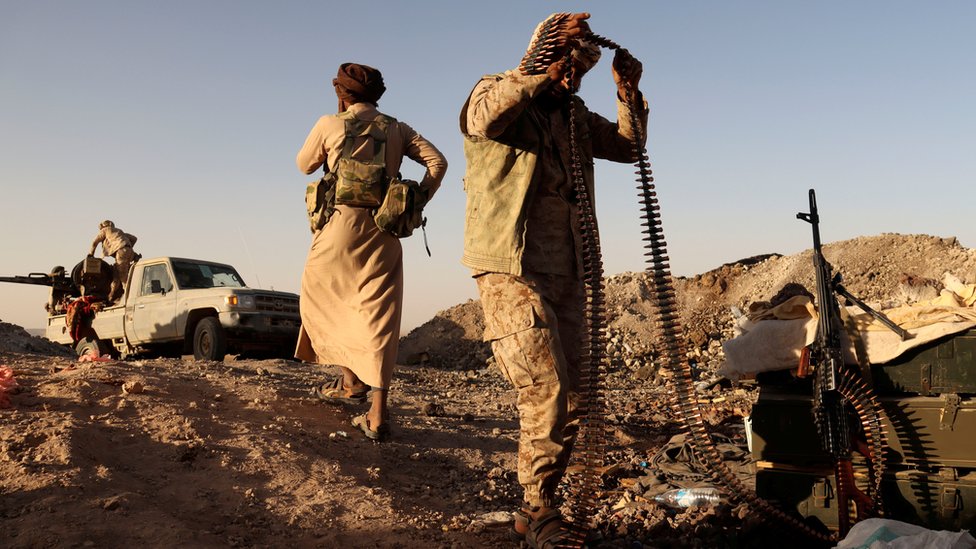 A Yemeni pro-government fighter holds a machine gun bullet belt at a frontline position during fighting against Houthi fighters in Marib, Yemen (16 March 2021) A Yemeni pro-government fighter holds a machine gun bullet belt at a frontline position during fighting against Houthi fighters in Marib, Yemen (16 March 2021)